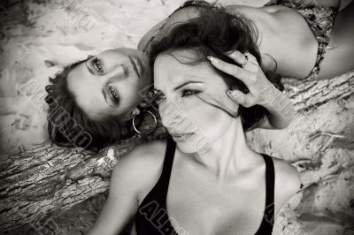 Two lovely girls lying on the beach