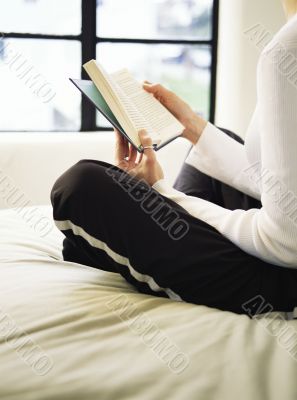 Reading a Book on Her Bed