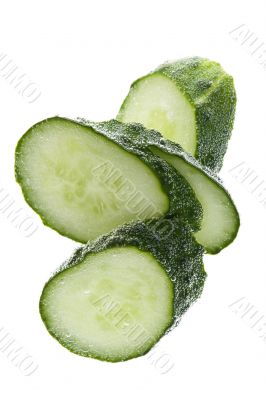 Cutting cucumber in water closeup
