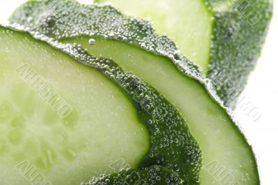 Cutting cucumber in water macro