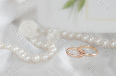 Closeup of wedding rings and beads