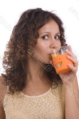 Girl is drinking orange juice.