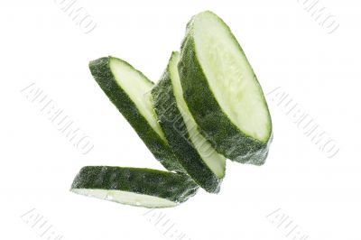Cut cucumber in water on white