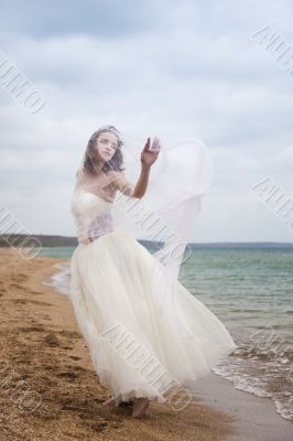 	beautiful bride  dancing on the beach