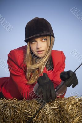 girl jockey / on a background of blue sky and hay