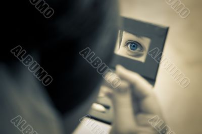 woman eye captured in the mirror