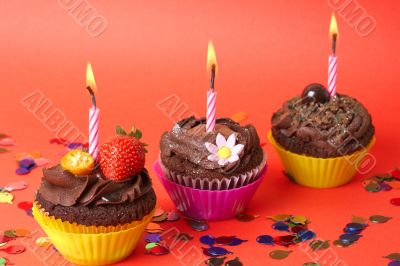 Miniature chocolate cupcakes with candle