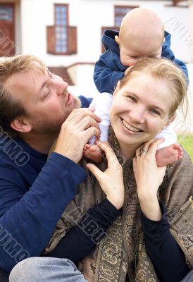 Happy family sitting on the grass