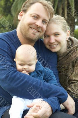 Happy family sitting in the garden