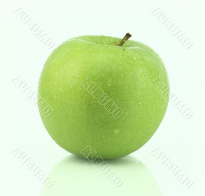 A fresh green apple with water drops