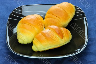 Close-up  bread loaf stacked on a black plate