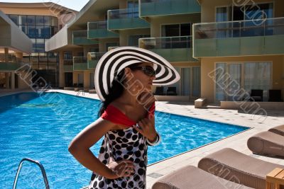 The beautiful model poses near pool