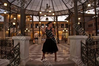 Fine model posing in the evening in an arbour