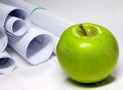 Green apple and sheet of paper on white background