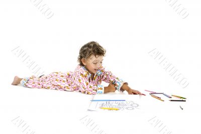 Boy with colouring book on white