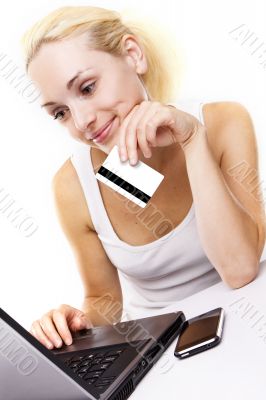 Woman using laptop, holding credit card