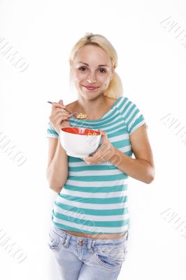 Young beautiful woman eating corn flakes