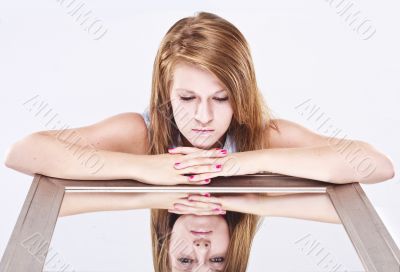 young woman looking into a mirror