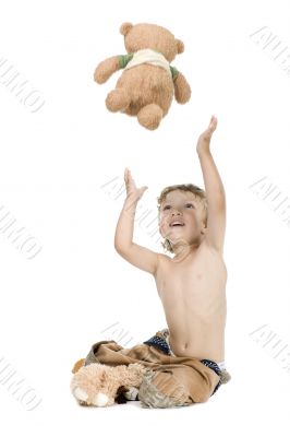 little boy play toy bear on white background