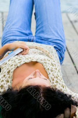 woman lying with book
