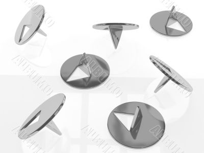 metallic thumbtacks (drawing pins) on white background