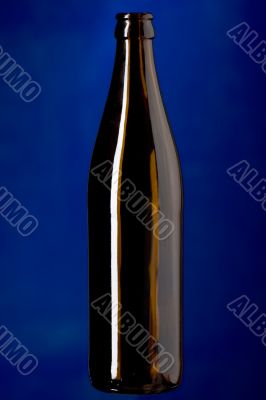 Glass bottle on blue closeup