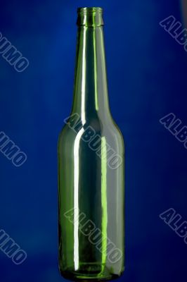 Green Glass bottle on blue