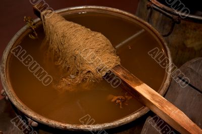 Coloured sheep`s wool into a colour pot