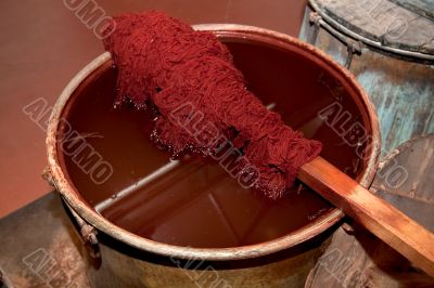 Coloured sheep`s wool into a colour pot