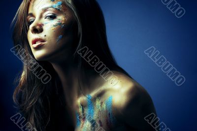 girl with bodyartposing on blue