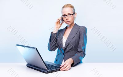 blonde businesswoman using laptop