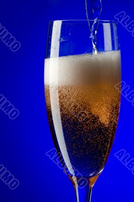 champagne glasses close up on blue