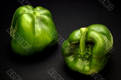 Two green sweet peppers