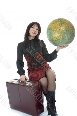 Beautiful brunette with valise and globe