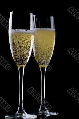 Two glasses champagne on black closeup