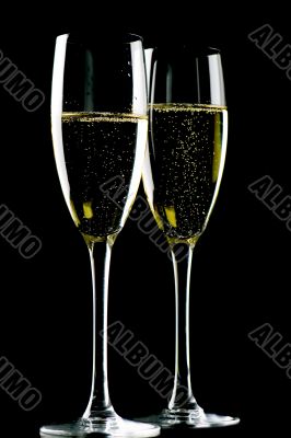 Two glasses champagne on black