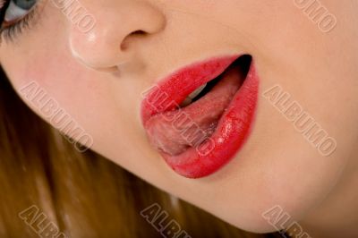 Beautiful woman leaking teeth with tongue close-up