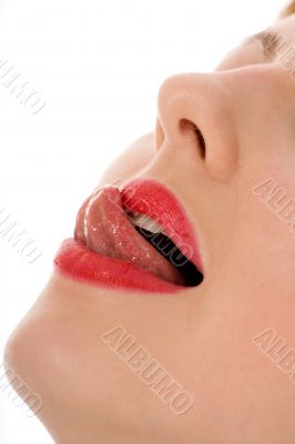 Beautiful woman leaking teeth with tongue close-up