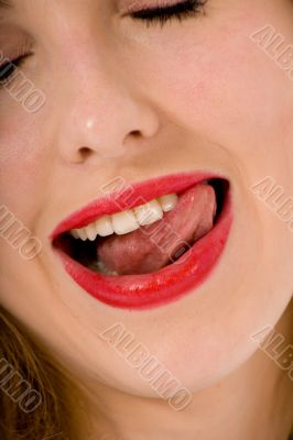 Beautiful woman leaking teeth with tongue close-up