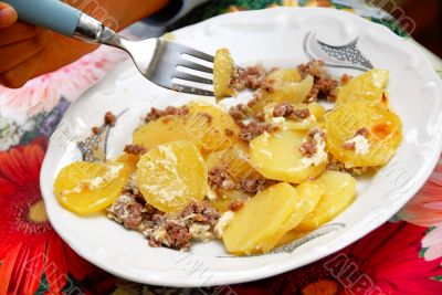 Baked potatoes with meat in plate