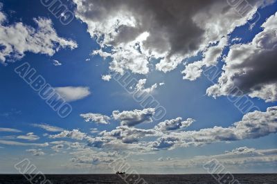 Single tanker ship far away in open sea