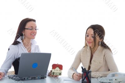 Two business woman advertises real estate on white