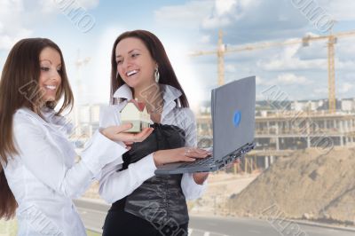Two business woman advertises real estate