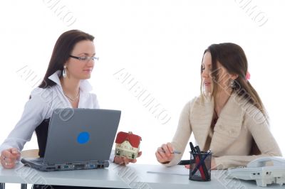 Two business woman advertises real estate on white
