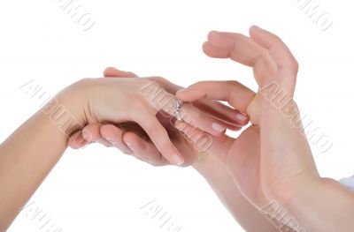 Man`s and female hands with a wedding ring