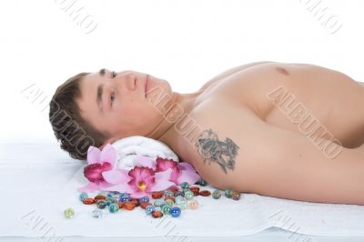 Attractive man getting spa treatment on white