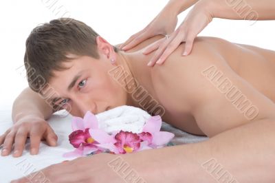 Attractive man getting spa treatment on white