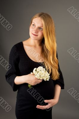 smiling gentle young pregnant blonde woman