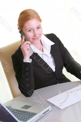Businesswoman with laptop and phone
