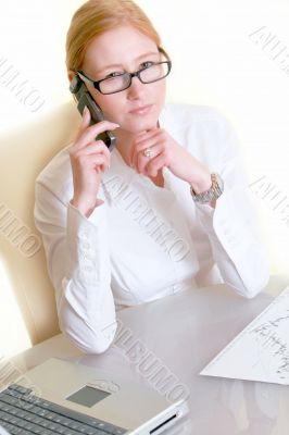 Business woman with glasses at the desk 